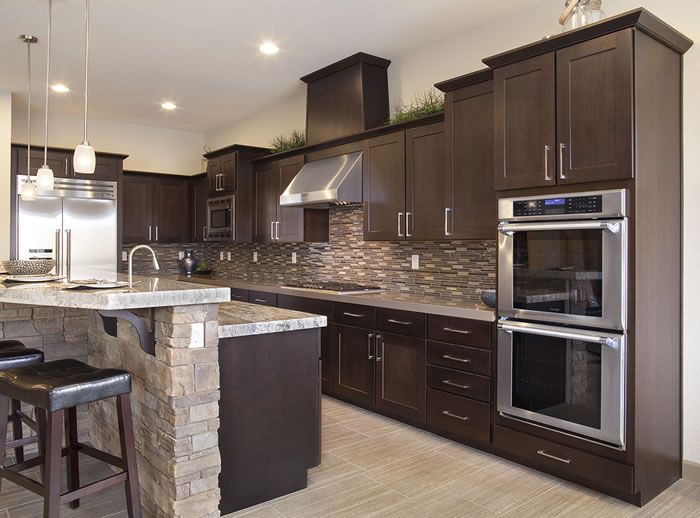 Kitchen with light stone countertops and custom cabinetry