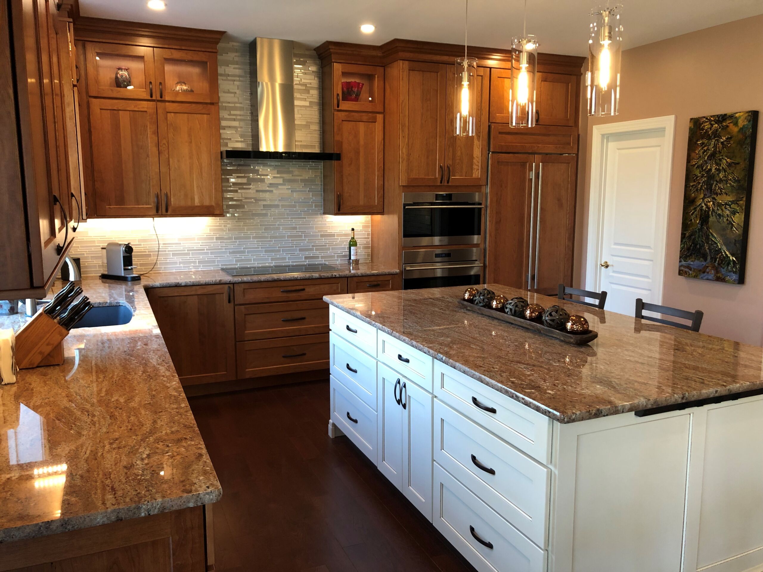 Modern kitchen with white quartz countertops and light wood cabinetry