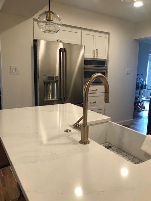 Kitchen with white quartz countertops and modern cabinetry