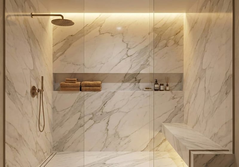 Close-up of Calacatta Gold Supreme polished marble slab showing intricate gold and grey veining