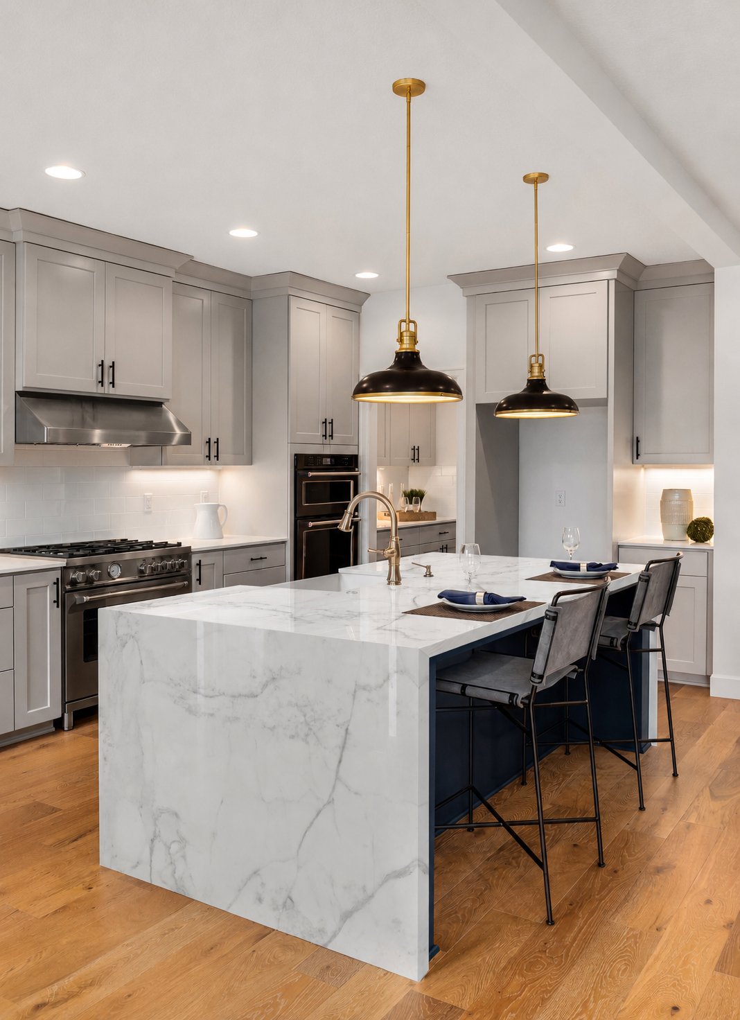 Modern kitchen with Calacatta Caldia polished marble countertops and backsplash, white cabinetry