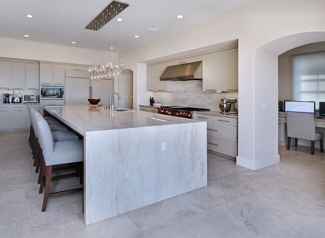 Elegant kitchen with marble-look quartz countertops and white cabinetry