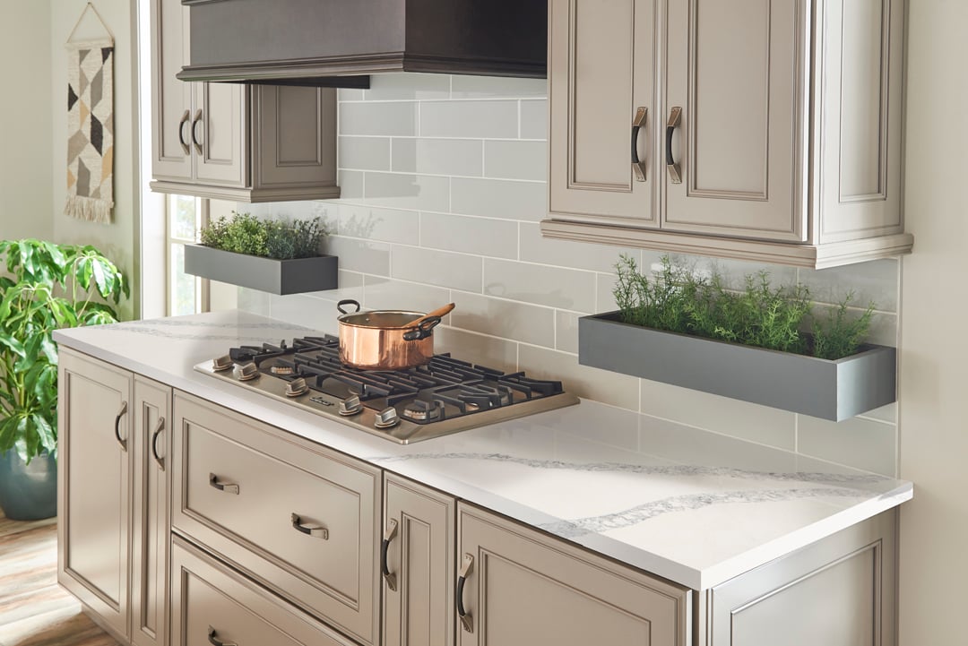 Close-up detail of kitchen countertop and backsplash with stone surface