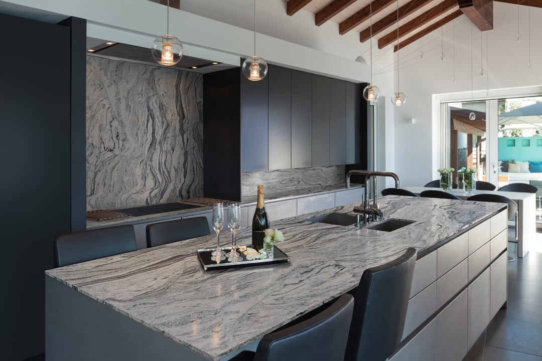Kitchen with quartz countertops, backsplash, and cabinetry
