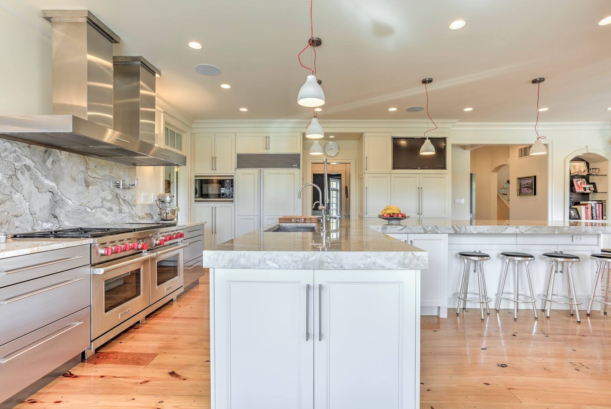 Bright kitchen with white cabinets, subway tile backsplash, and granite countertops