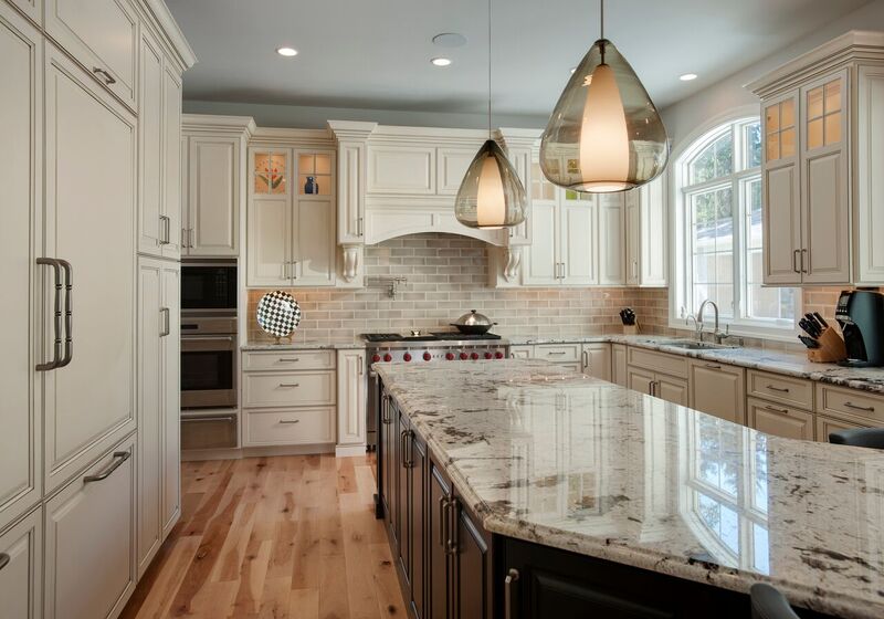 Kitchen with stone countertops and white cabinetry