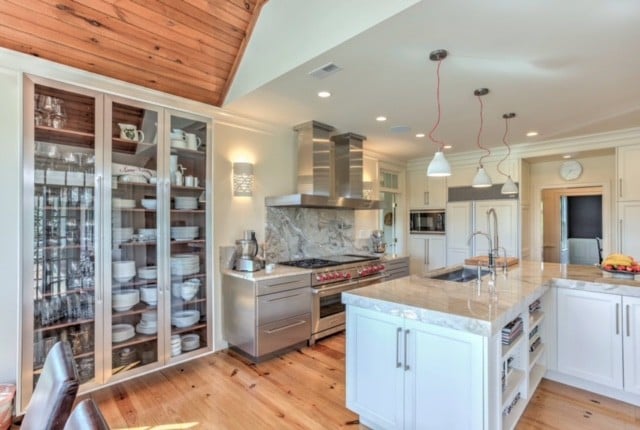 Modern kitchen with dark cabinetry and light stone countertops
