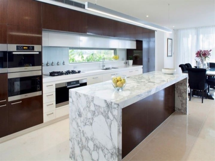 Kitchen with marble or marble-look countertops and cabinetry