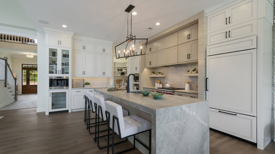 Model home kitchen with stone countertops and cabinetry
