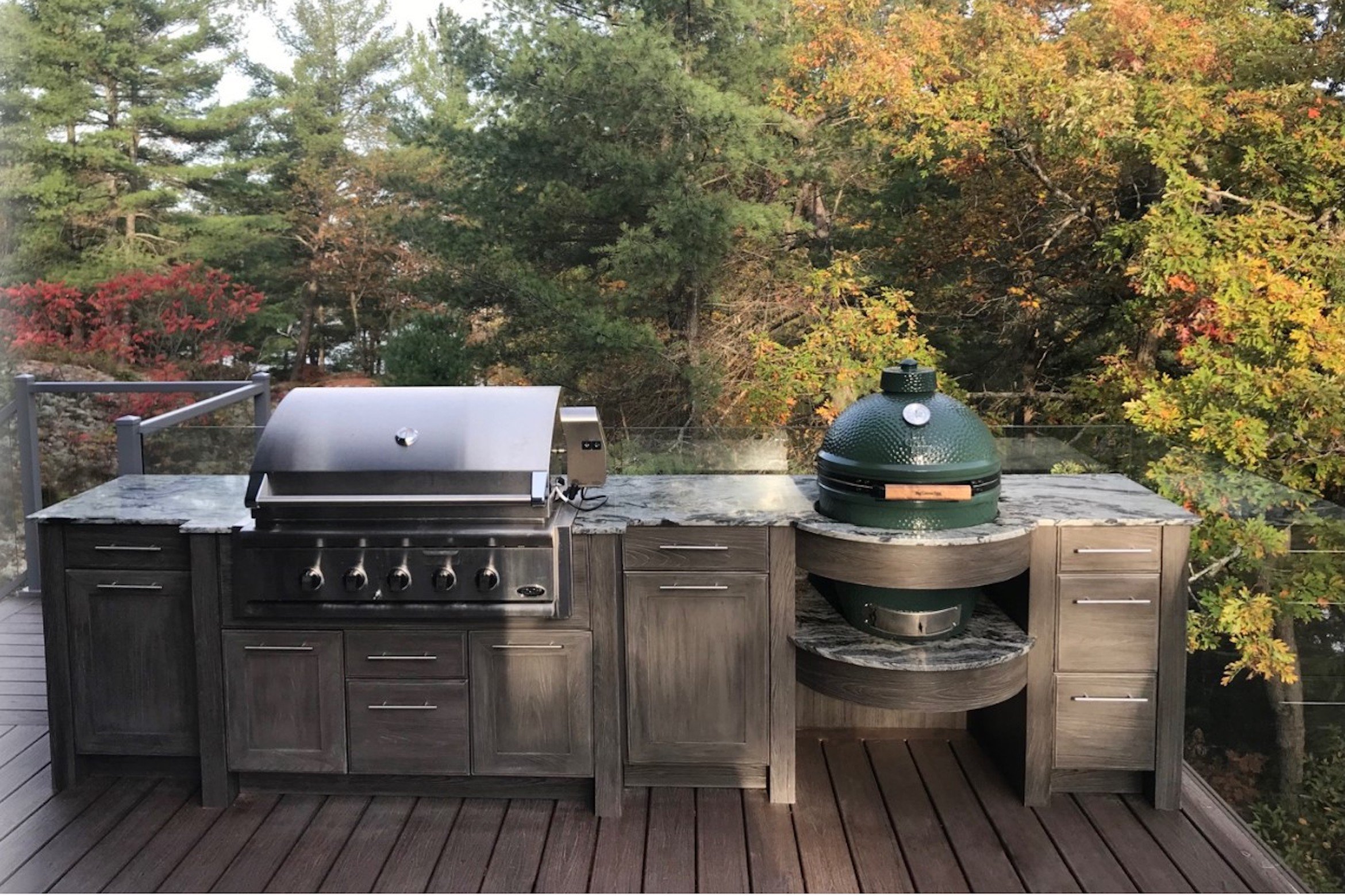 Outdoor kitchen with built-in grill and stone countertop