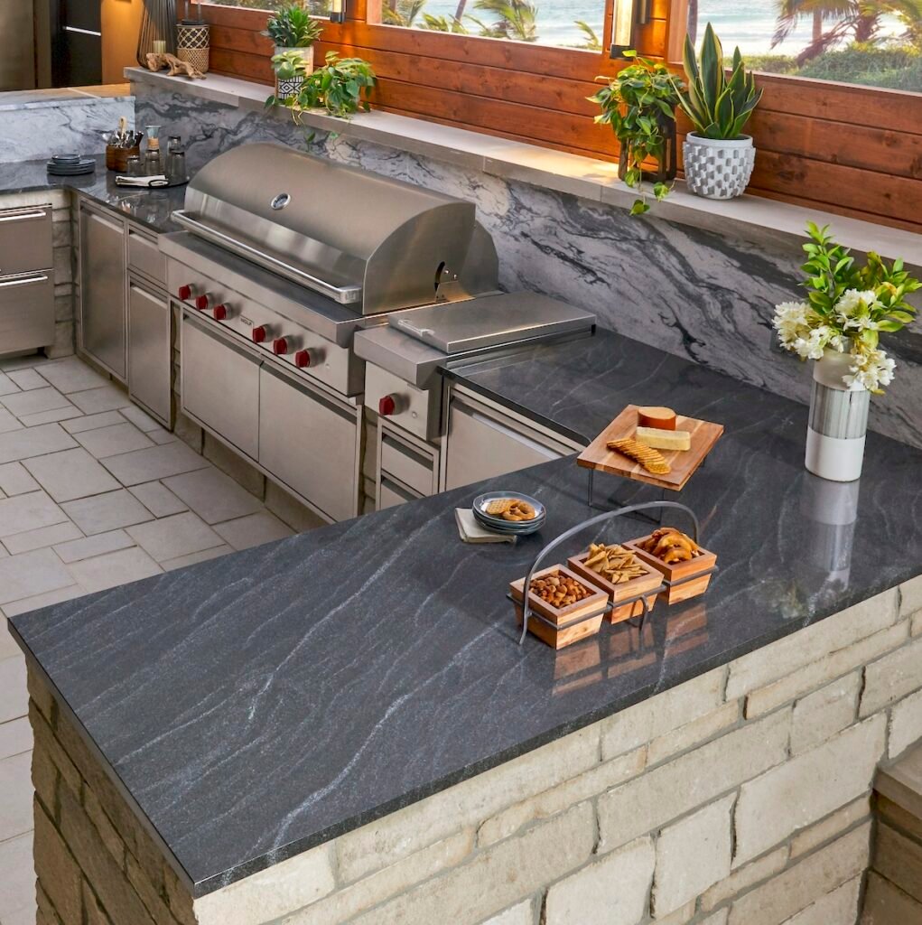 Outdoor kitchen with Virginia Mist granite countertop and built-in appliances