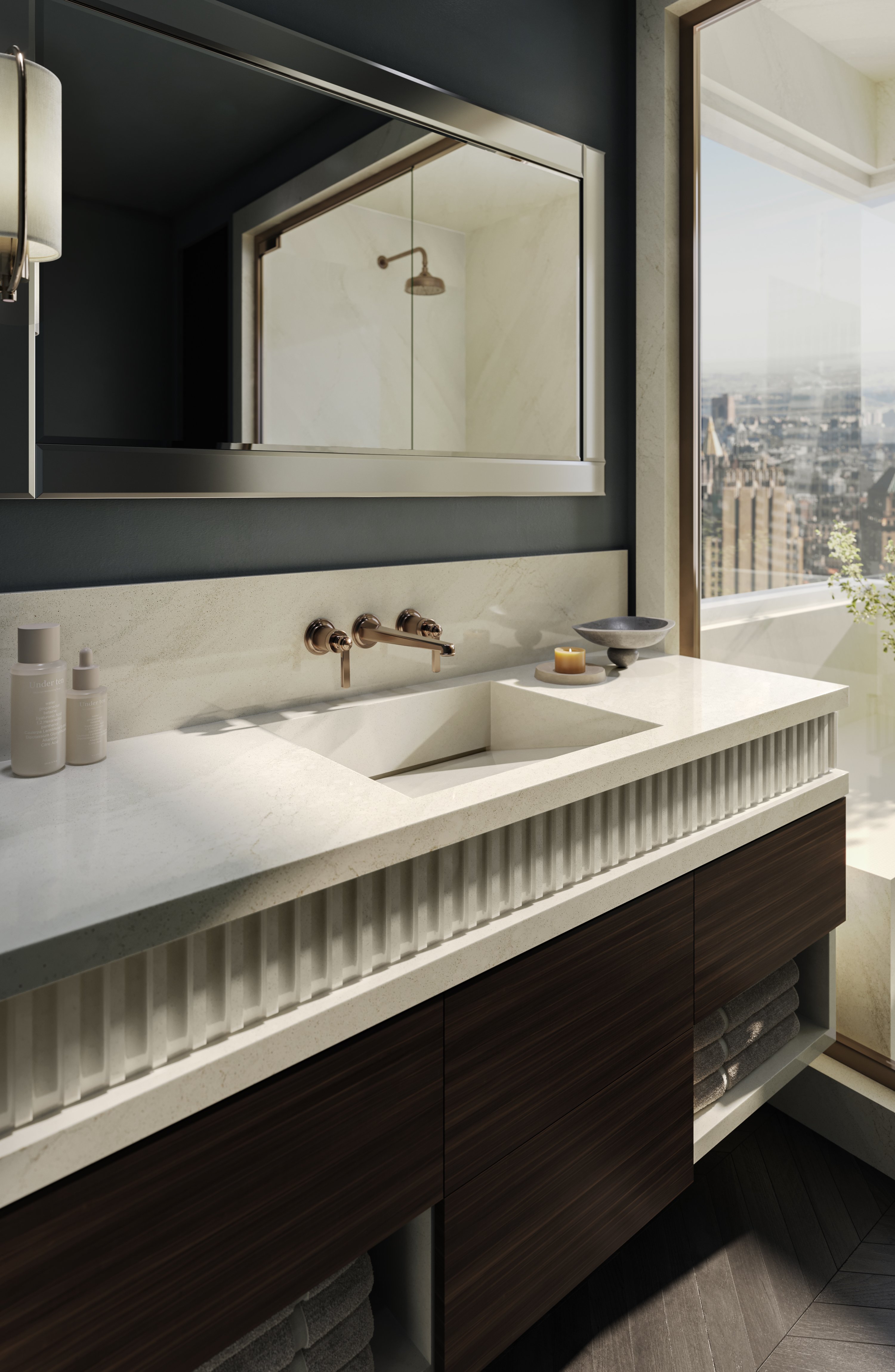 Bathroom featuring bay-toned stone tile walls, soaking tub, and elegant fixtures