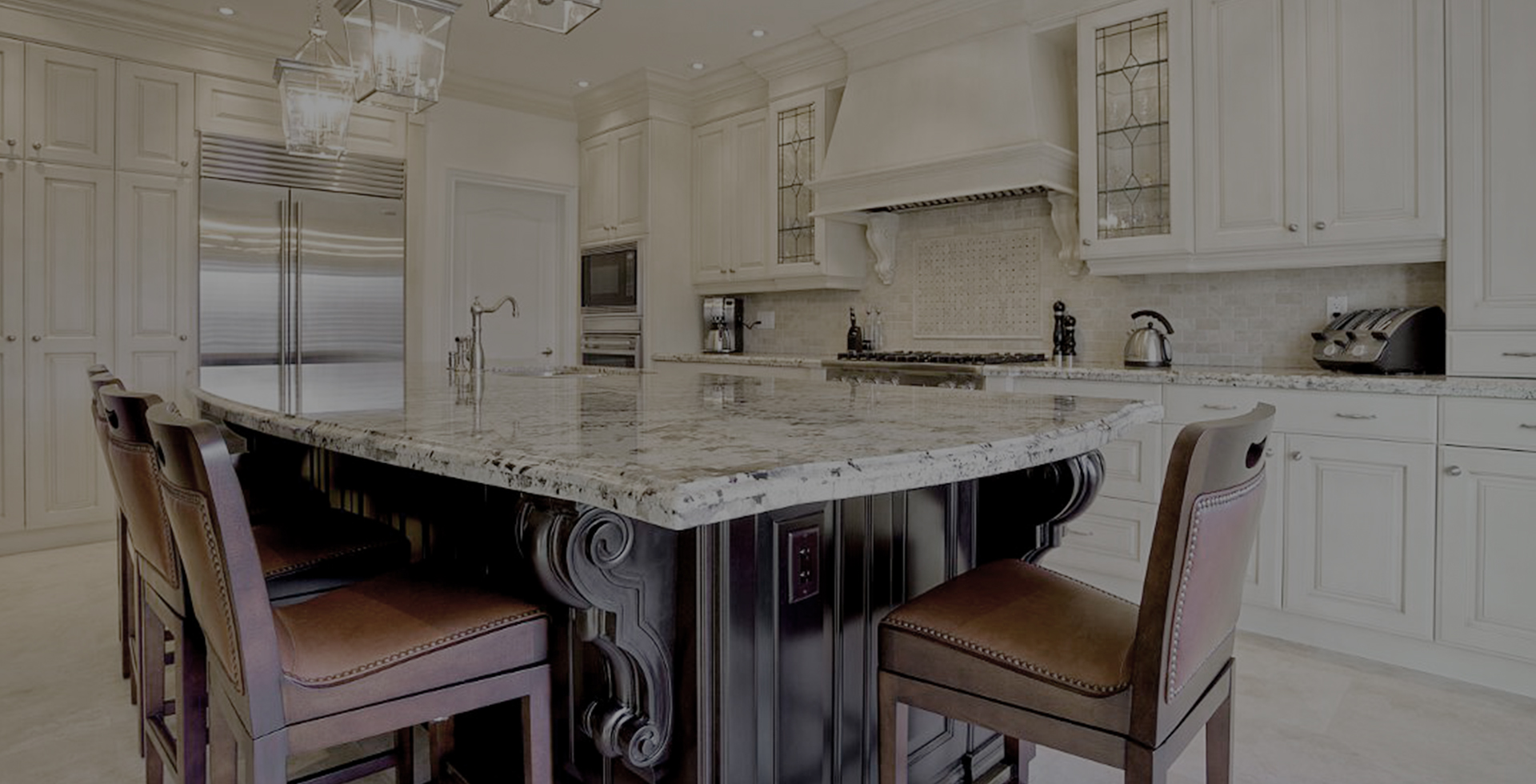 A modern kitchen with white shaker cabinets and a fancy marble island in the middle with chairs.